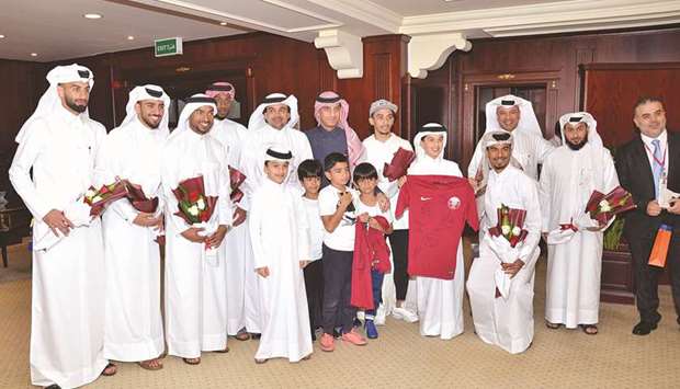 Dr Abdulbasit Ahmad al-Shaibei and other senior QIIB executives with some players of the Qatari football team that won the 2019 AFC Asian Cup football  championship.