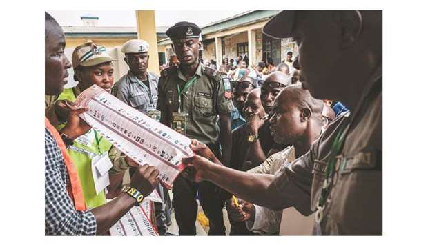 Officials count votes in front of voters during the presidential and parliamentary elections at a polling station in Port Harcourt, southern Nigeria.