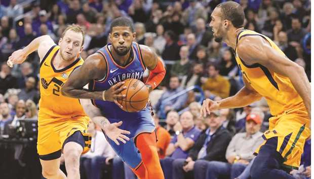 Oklahoma City Thunder forward Paul George (centre) drives down the court between Utah Jazz forward Joe Ingles (left) Utah Jazz centre Rudy Gobert during the first-half of their NBA game at Chesapeake Energy Arena. PICTURE: USA TODAY Sports