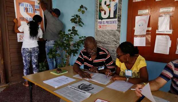 Officials prepare a polling station for the constitutional referendum in Havana, Cuba on February 17.