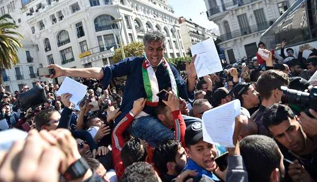 Algerian businessman and political activist Rachid Nekkaz (centre) arrives in front of the city hall of Algiers during a gathering for his supporters, yesterday.