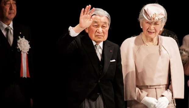 Japanese Emperor Akihito and Empress Michiko leave from a stage as Prime Minister Shinzo Abe looks on, during a ceremony marking the 30th anniversary of Emperor Akihito's enthronement at the National Theatre in Tokyo