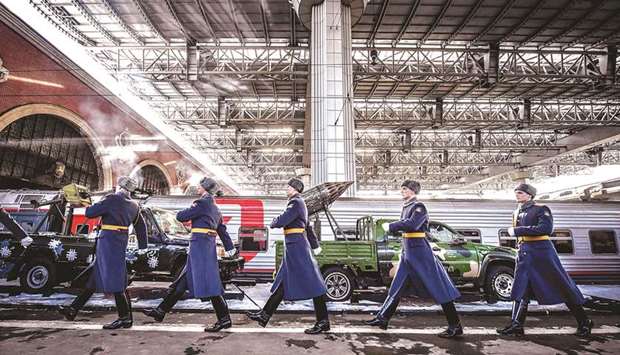 Russian honour guard soldiers march next to the train with the u2018Syrian turning pointu2019 exhibition pieces organised by Russian defence ministry, as it waits to depart from Kazansky railway station in Moscow.