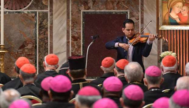 A victim of abuse, who wished to remain anonymous, plays the violin after delivering his testimony before Pope Francis and an assembly of cardinals and bishops, during a liturgical prayer on the third day of a landmark Vatican summit on tackling paedophilia in the clergy.