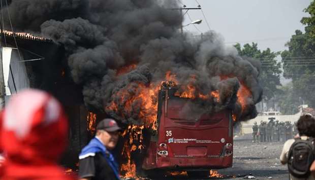 A bus burns down during a protest in the border city of Urena, Tachira, after President Nicolas Maduro's government ordered a temporary close-down of the border with Colombia