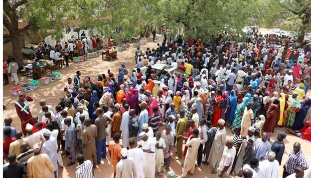 People gather to vote during Nigeria's presidential election at a polling station in Yola, Adamawa State yesterday.