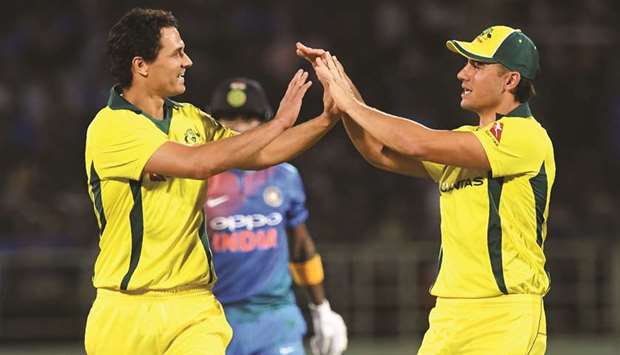 Australian players Nathan Coulter-Nile (left) and Marcus Stoinis celebrate the wicket of Indian opener Lokesh Rahul during the first Twenty20 at the Dr.Y.S. Rajasekhara Reddy ACAu2013VDCA Cricket Stadium in Visakhapatnam yesterday. (AFP)