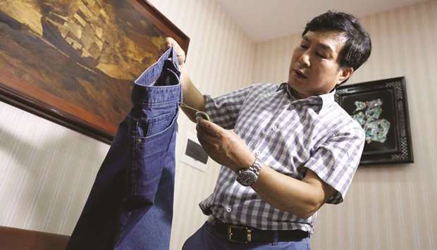 Choi Dong-jin, president of South Korean garment maker DMF who was forced to close his factory in North Koreau2019s Kaesong industrial complex and then moved his manufacturing business to Vietnam in 2016, shows his product made in Kaesong at his office in Hanoi, Vietnam, on February 22, 2019.