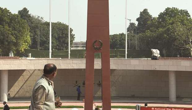 A labourer walks past the National War Memorial near India Gate in New Delhi yesterday. Prime Minister Narendra Modi will inaugurate the memorial today.
