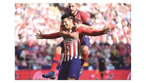 Atletico Madridu2019s Alvaro Morata celebrates with midfielder Koke (back) after scoring  against Villarreal at the Wanda Metropolitano stadium in Madrid yesterday.