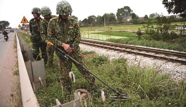 A Vietnamese soldier uses a mine-sweeper while patrolling on the road between Hanoi and the Dong Dang railway station near the Chinese border, in Bac Giang yesterday, ahead of the second Trump-Kim summit.
