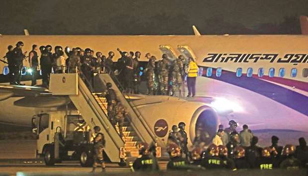 Security personnel stand guard near a Dubai-bound Bangladesh Biman plane on the tarmac of the Shah Amanat International Airport in Chittagong yesterday, following an emergency landing after a man apparently attempted to hijack the aircraft.