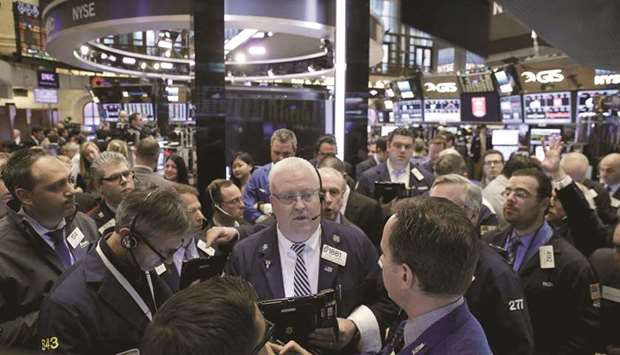 Traders work on the floor of the New York Stock Exchange (file). A return to fashion of growth stocks in 2019 helped lead the overall US market out of a year-end shakeout, but another multi-year run of growth performing better than value may not be in the cards.