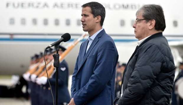 Venezuelan opposition leader Juan Guaido (L) next to Colombian Foreign Minister Carlos Holmes Trujillo speaking upon arrival in Bogota, Colombia. AFP/Colombian Presidency / Efrain Herrera