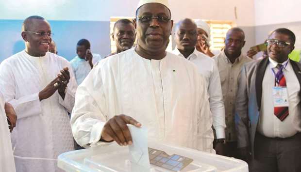 Incumbent President Macky Sall casts his vote for Senegalu2019s presidential elections in a ballot box at a polling station in Fatick, yesterday.