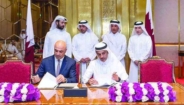 HE the Prime Minister and Interior Minister Sheikh Abdullah bin Nasser bin Khalifa al-Thani, HE the Minister of Finance Ali Sherif al-Emadi, QNTC secretary general and Qatar Airways Group chief executive Akbar al-Baker and other dignitaries at the signing ceremony.