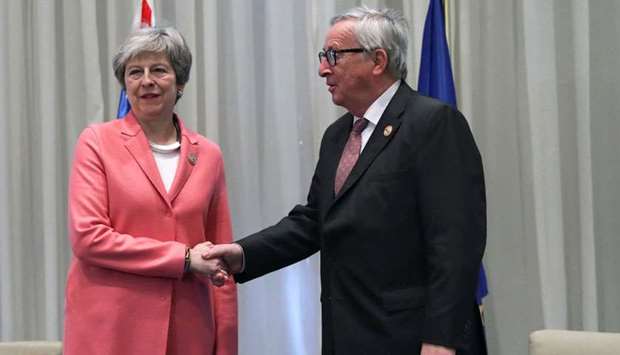 Britain's Prime Minister Theresa May poses with European Commission President Jean-Claude Juncker during a summit between Arab league and European Union member states, in the Red Sea resort of Sharm el-Sheikh, Egypt