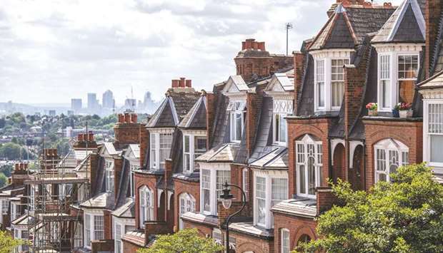 A terraced row of residential housing sits in the Muswell Hill district, in view of the Canary Wharf financial, business and shopping district of London (file). Islamic banks in the UK have a significant exposure to real estate at about 67%.
