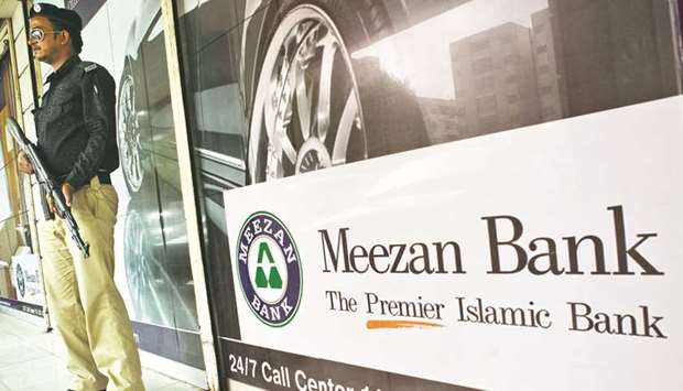 A security guard stands outside a Meezan Bank branch in Karachi (file). Pakistanu2019s central bank has given the go-ahead to Islamic banks to offer cheaper refinancing to priority areas  including SMEs, agriculture and renewable energy.