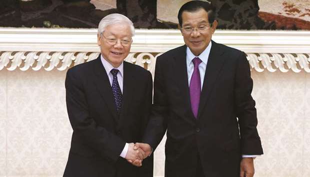 Cambodian Prime Minister Hun Sen, right, and Vietnamese President Nguyen Phu Trong shake hands on arrival at the Peace Palace in Phnom Penh yesterday.