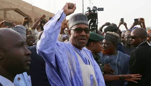 Nigerian President Muhammadu Buhari gestures as he arrives to cast a vote in Nigeria's presidential election at a polling station in Daura, Katsina State, Nigeria on February 23.