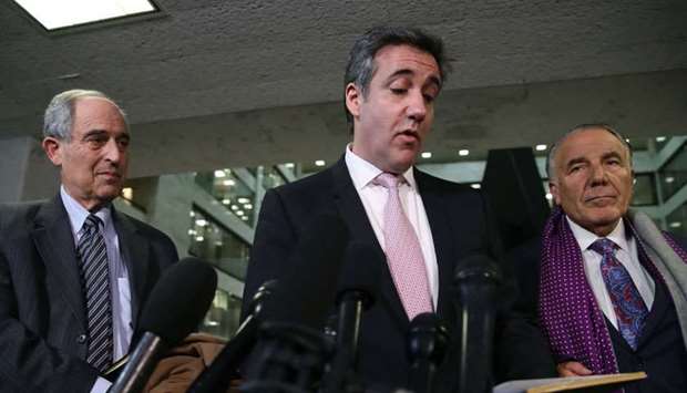 Michael Cohen (C), former attorney and fixer for President Donald Trump, reads a statement to the media at the Hart Senate Office Building after testifying to the Senate Intelligence Committee on Capitol Hill February 26 in Washington, DC
