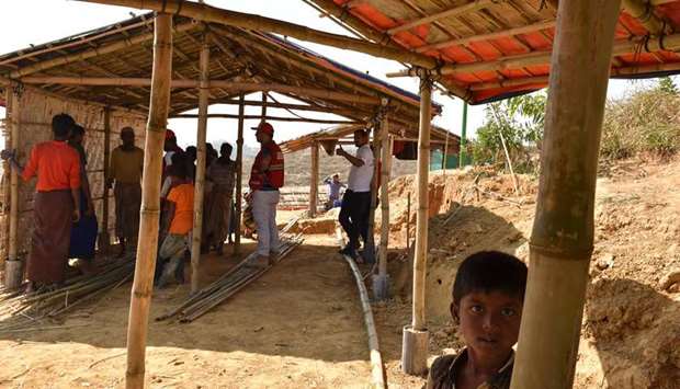 Work in progress on the shelters at the Rohingya refugee camp.