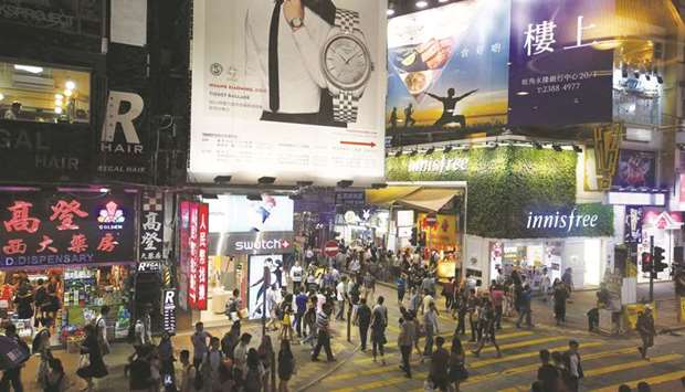 People walk at the Mongkok shopping district. Hong Kongu2019s open and trade-reliant economy has been buffeted by external risks, including an economic slowdown in China, cooling property prices and stock market volatility.