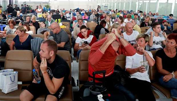 Passengers pass their time after Thai Airway cancelled all the flights to and from Europe at Suvarnabhumi Airport in Bangkok.