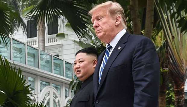 US President Donald Trump (R) walks with North Korea's leader Kim Jong Un during a break in talks at the second US-North Korea summit at the Sofitel Legend Metropole hotel in Hanoi