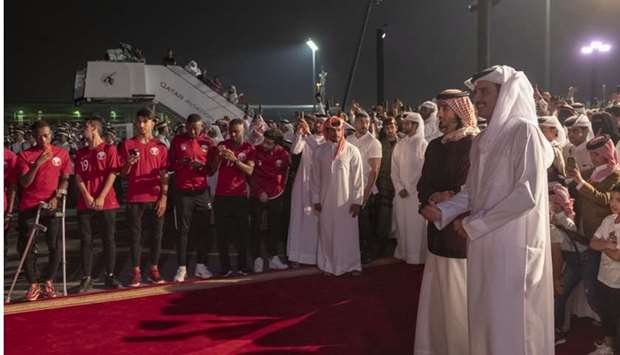 His Highness the Amir Sheikh Tamim bin Hamad al-Thani and His Highness the Personal Representative of the Amir Sheikh Jassim bin Hamad al-Thani await the arrival of the Qatar national team at the old airport.