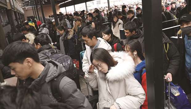Passengers enter Beijing Railway Station in Beijing yesterday.