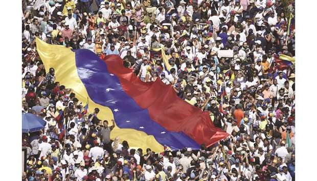 Opposition activists rally to back Venezuelan opposition leader Juan Guaidou2019s calls for early elections in Caracas yesterday.