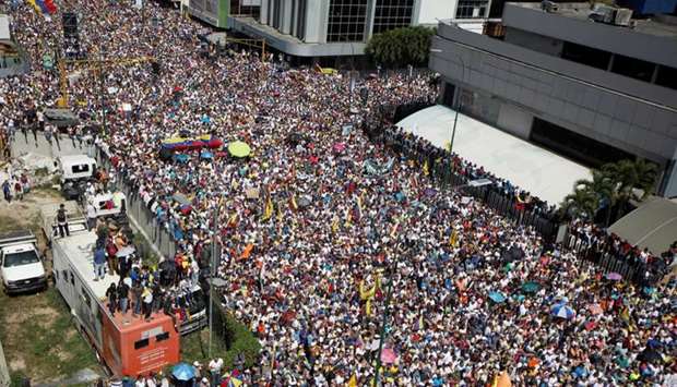 Opposition supporters take part in a rally against Venezuelan President Nicolas Maduro's government in Caracas yesterday. Reuters