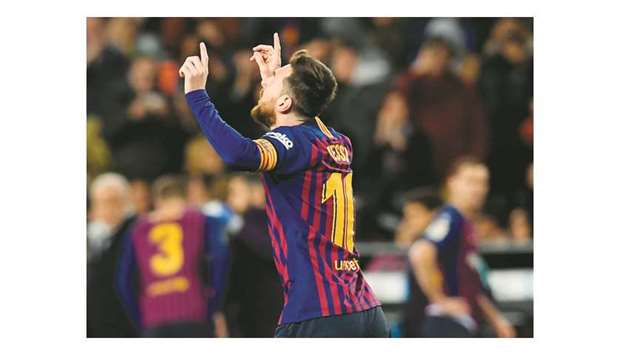 Barcelonau2019s Argentinian forward Lionel Messi celebrates after scoring against Valencia CF at the Camp Nou stadium in Barcelona on Saturday night.