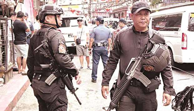 Manila Police District police personnel gear up for the upcoming celebration of Chinese New Year by conducting vicinity checks in Chinatown, Binondo, Manila to prevent acts of violence.