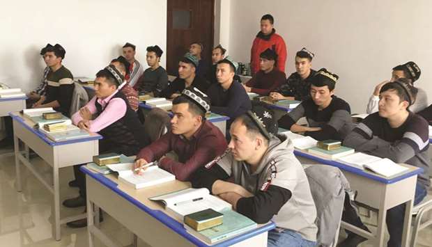 In this file picture, Islamic studies students attend a class at the Xinjiang Islamic Institute during a government organised trip in Urumqi, Xinjiang Uighur Autonomous Region, China.