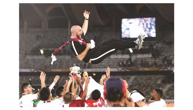 That heady feeling:  File photo of Qatar coach Felix Sanchez being tossed up in the air after the team beat Japan to win the Asian Cup on Friday.