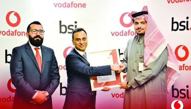 Vodafone Qatar CEO Sheikh Hamad Abdulla Jassim al-Thani receiving the certificate from British ambassador Ajay Sharma.