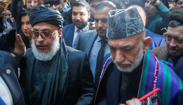 Afghan former President Hamid Karzai and Head of Political Office of the Taliban Sher Mohammad Abbas Stanakzai head for a conference arranged by the Afghan diaspora, in Moscow