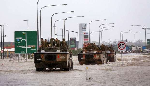 Army vehicles enter Townsville to help evacuate flood-affected people from Townsville