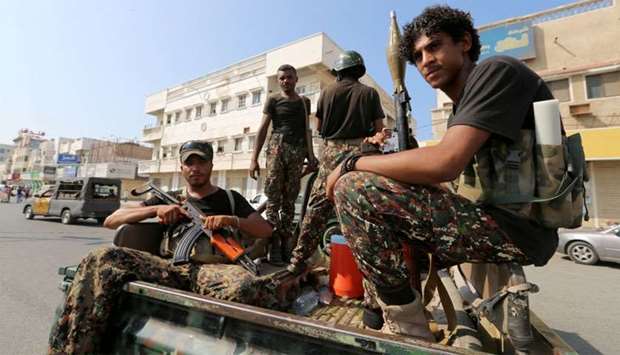 Houthi militants patrol a street where pro-Houthi demonstrated in Hodeidah
