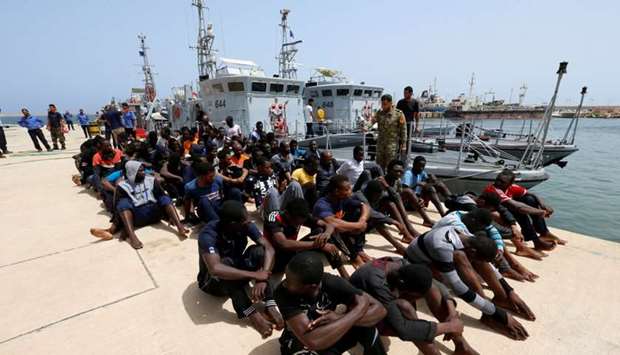 Migrants sit at a naval base after being rescued by Libyan coastguards in Tripoli, Libya on July 3, 2018. Reuters