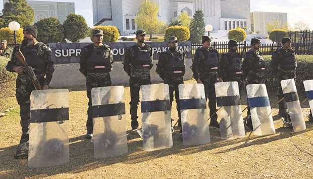 In this file photo, paramilitary soldiers stand guard outside the Supreme Court building in Islamabad.