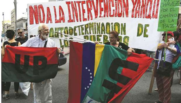 People demonstrate in favour of Venezuelan President Nicolas Maduro with a sign reading u201cNo to Yankee interventionu201d outside the Presidency building in Montevideo yesterday where a meeting to negotiate a solution to the Venezuelan crisis is taking place.