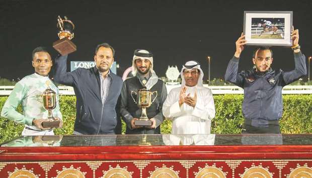 Qatar Racing and Equestrian Club Racing manager Abdulla Rashid al-Kubaisi with the winners of the Al Wajba Cup after Topsy Turvy won the feature on dirt yesterday. PICTURES: Juhaim