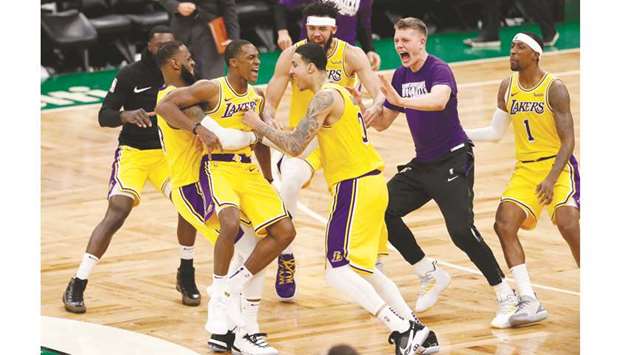LA Lakers guard Rajon Rondo (third from left) celebrates with his teammates after making the game-winning basket against the Boston Celtics on Thursday. (USA TODAY Sports)