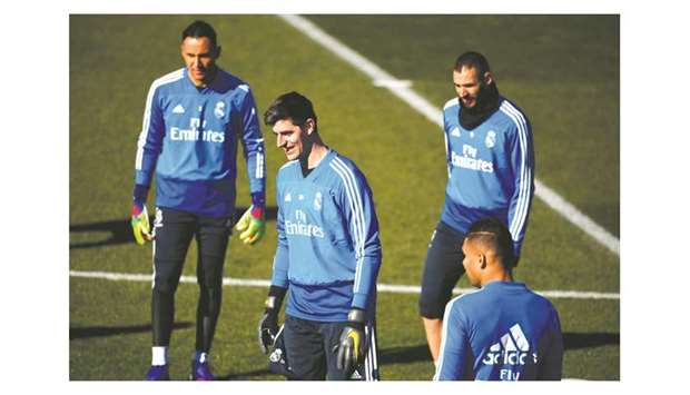 Real Madridu2019s goalkeeper Thibaut Courtois (centre) trains with his teammates. (AFP)