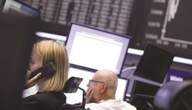 Traders monitor financial data inside the Frankfurt Stock Exchange. The DAX 30 ended 1.1% down at 10,906.78 points yesterday.
