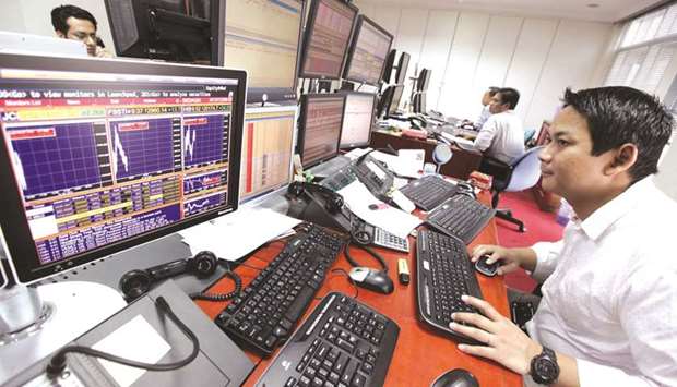 A trader looking at his screen as he keeps an eye on the stock market at a securities brokerage in Jakarta (file). As Indonesiau2019s benchmark stock gauge flirts with a fresh record u2013 it closed within 2.3% of it on Thursday u2013 even foreign investors have come back to the market.